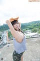 A woman in a hat is posing for a picture.