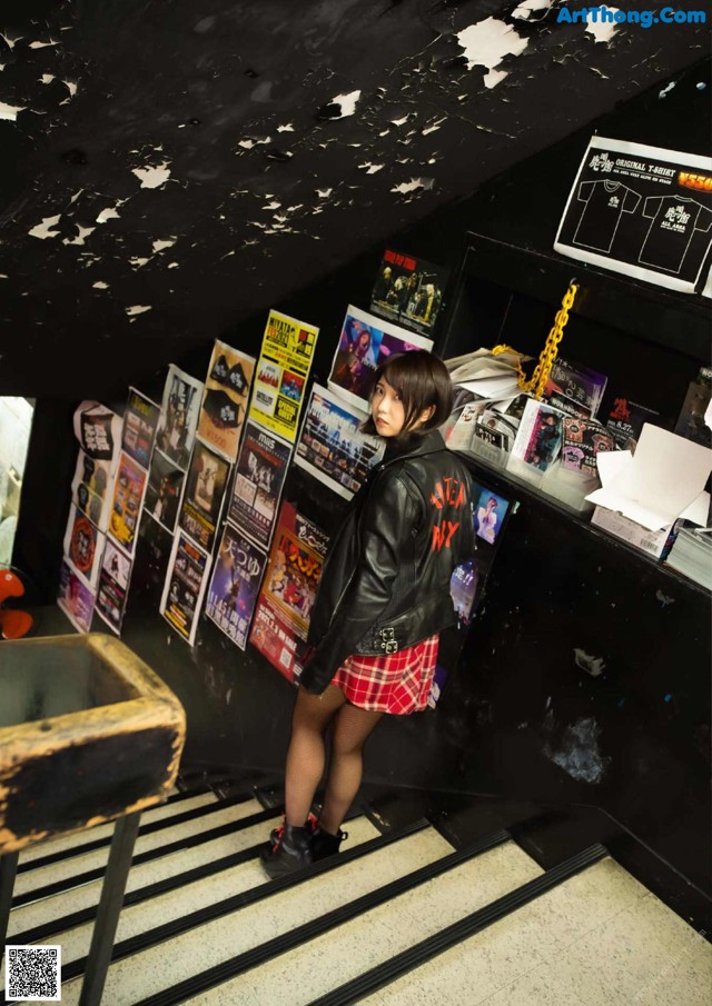 A woman standing on a set of stairs in a room.